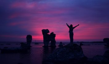 woman on ledge at sunrise