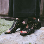 black sandals studded with gold
